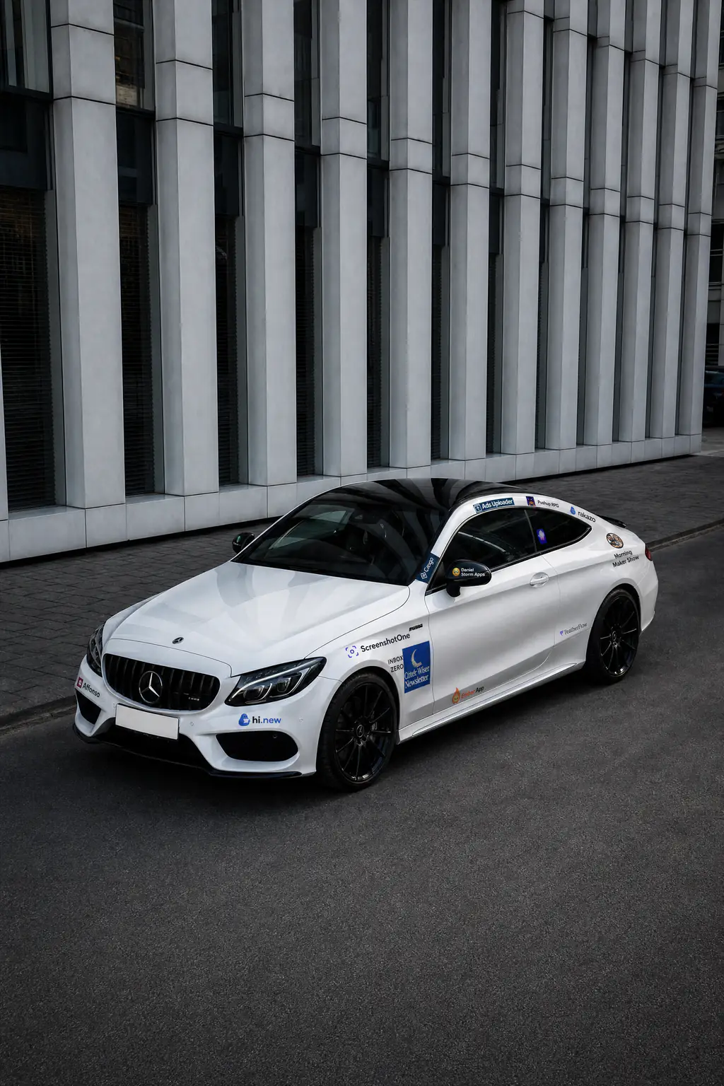 The white Mercedes-AMG coupe wearing sponsor logos